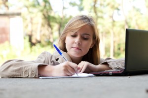 http://www.dreamstime.com/stock-photography-writing-female-student-working-laptop-image21751002